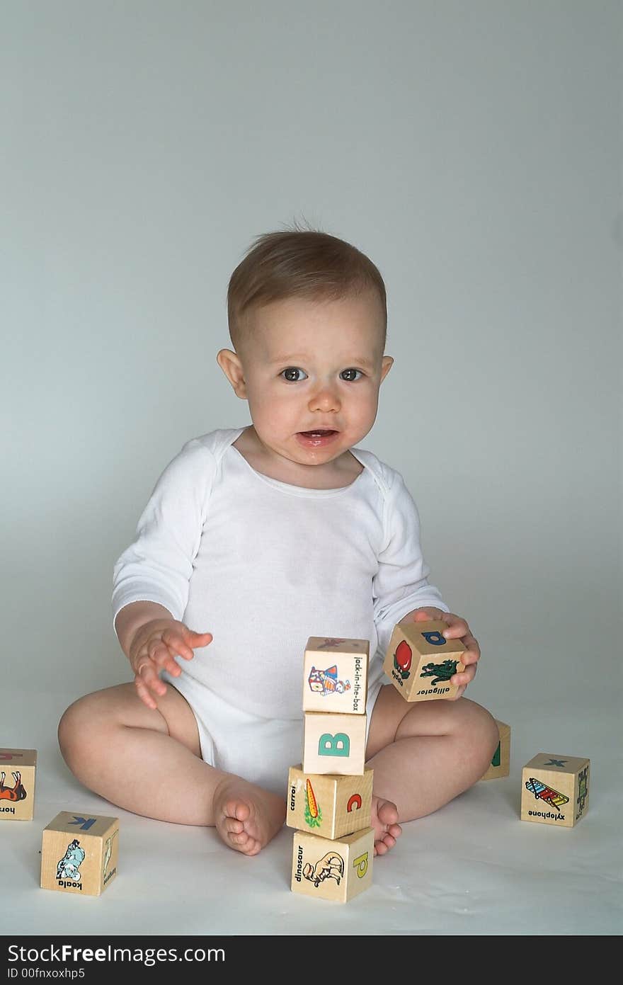 Image of cute baby playing with alphabet blocks. Image of cute baby playing with alphabet blocks