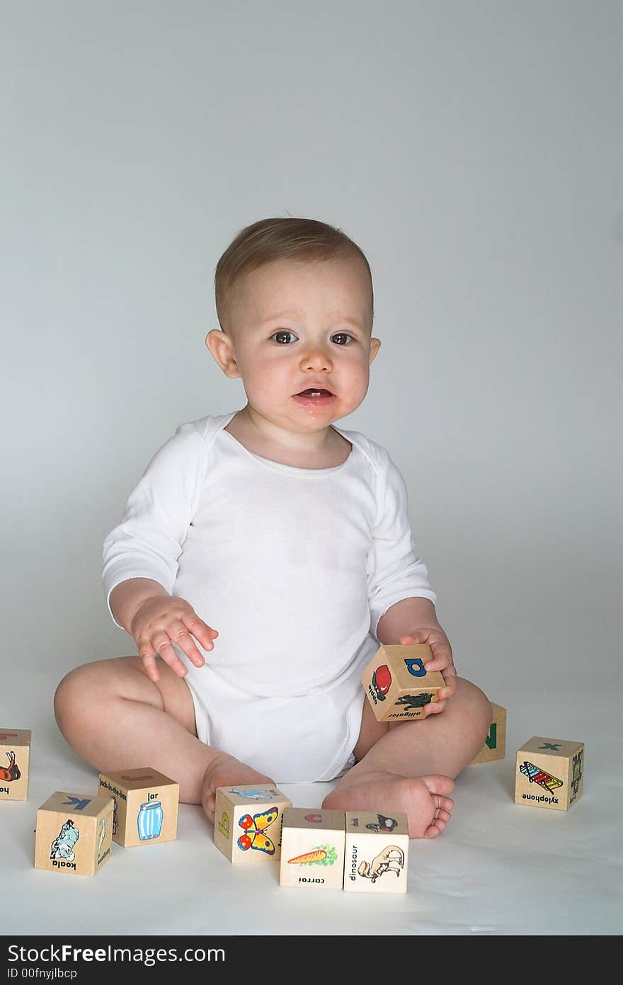 Image of cute baby playing with alphabet blocks. Image of cute baby playing with alphabet blocks