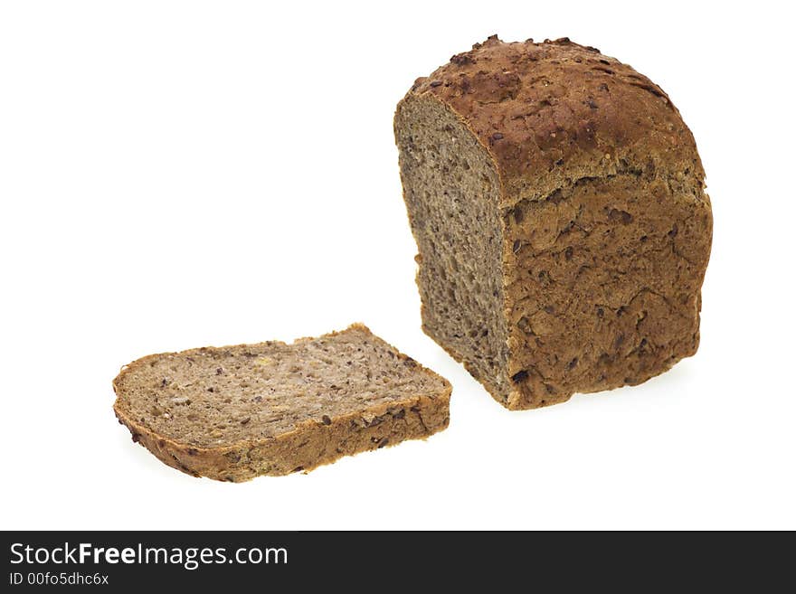 Loaf of cereal rye bread and slice isolated on white background