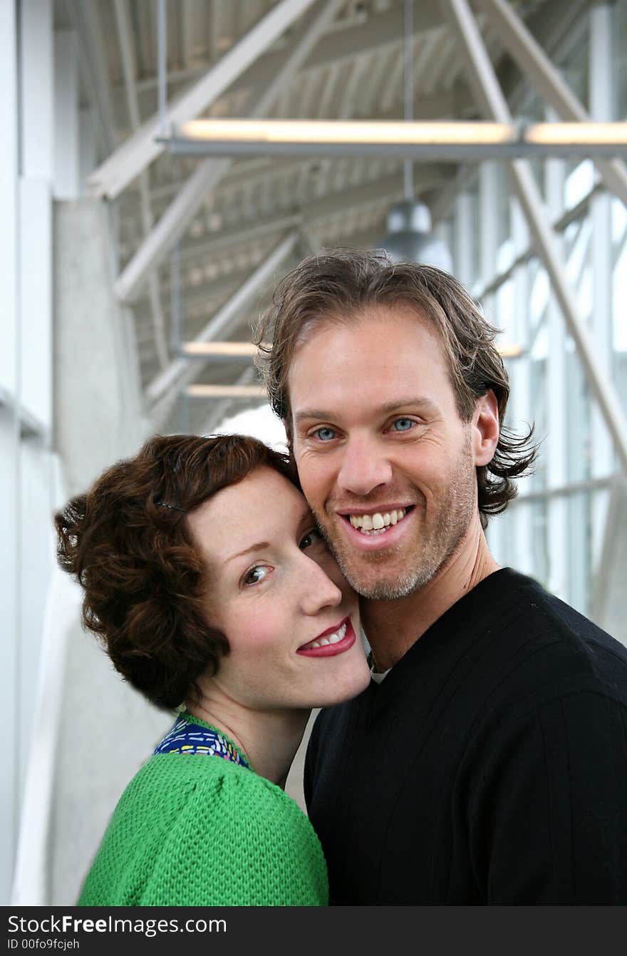 Image of a young and attractive couple in love...shot in a modern building setting. Image of a young and attractive couple in love...shot in a modern building setting