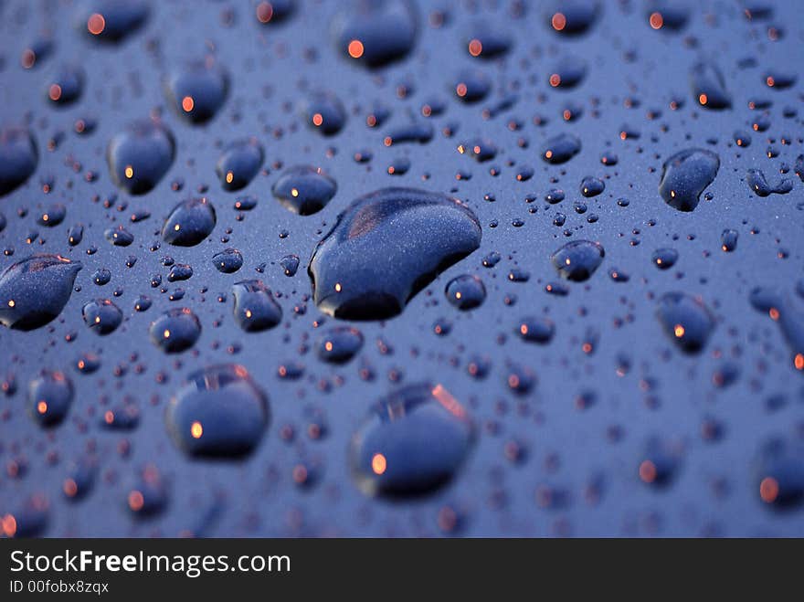 Water droplets and light on the car surface