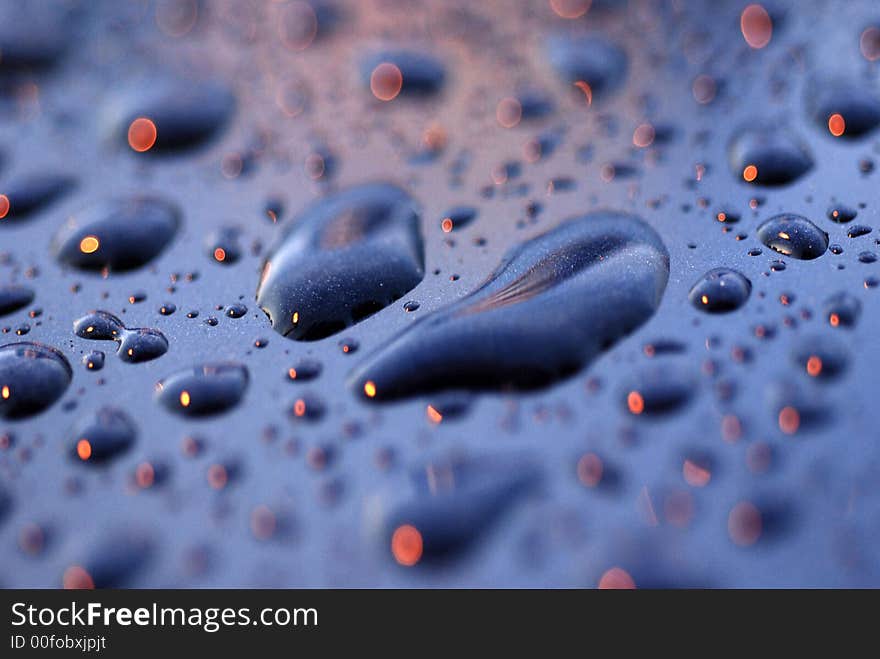 Water droplets and light on the car surface