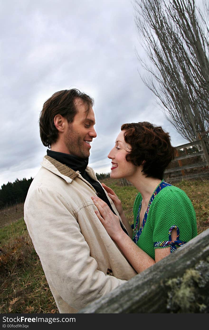 Image of a young loving couple in a rural setting. Image of a young loving couple in a rural setting.