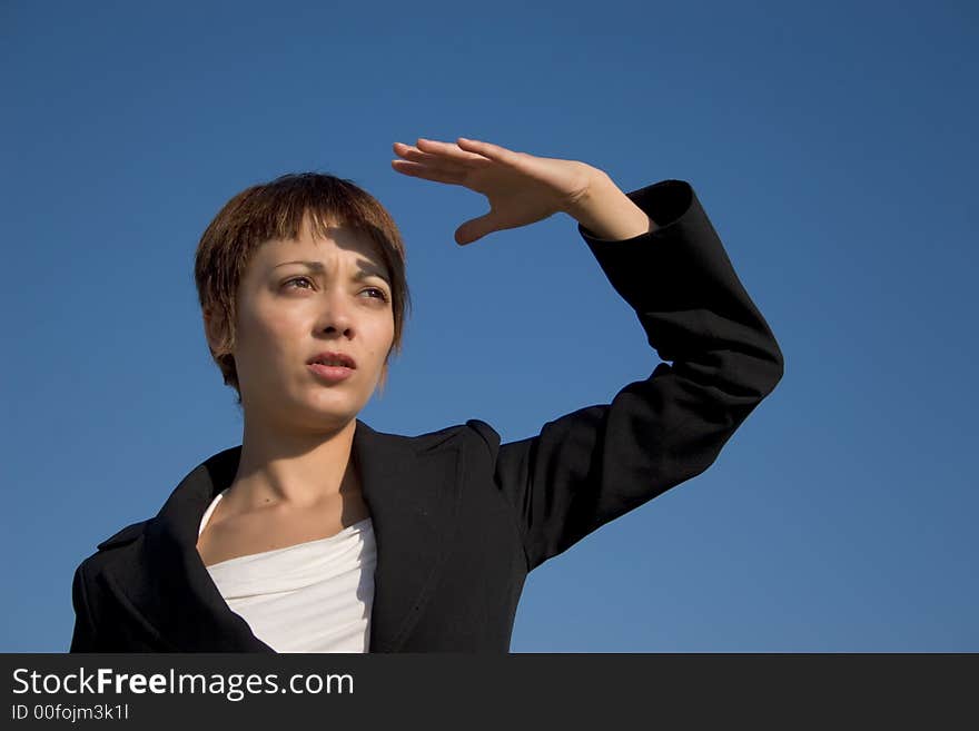 Businesswoman looking with far the hand on the face. Businesswoman looking with far the hand on the face