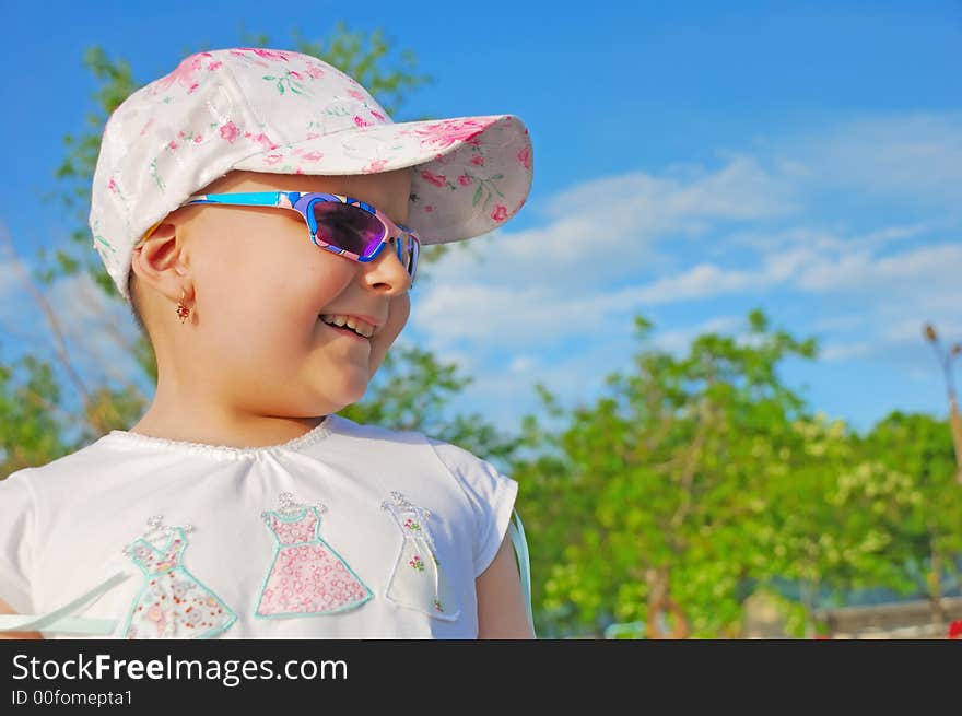 Laughing kid on cloudy sky background