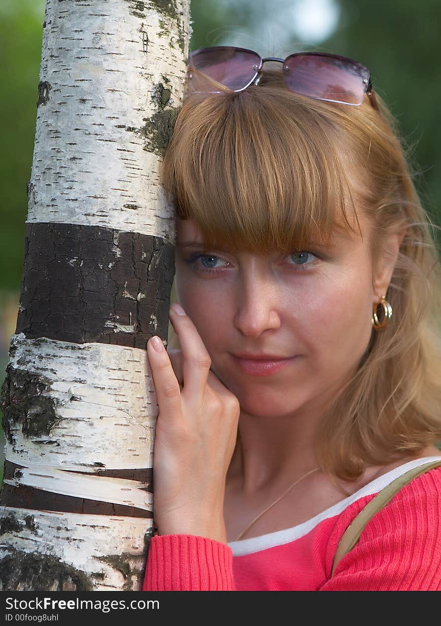 Portrait of the young beautiful girl near to a trunk of a birch. Portrait of the young beautiful girl near to a trunk of a birch