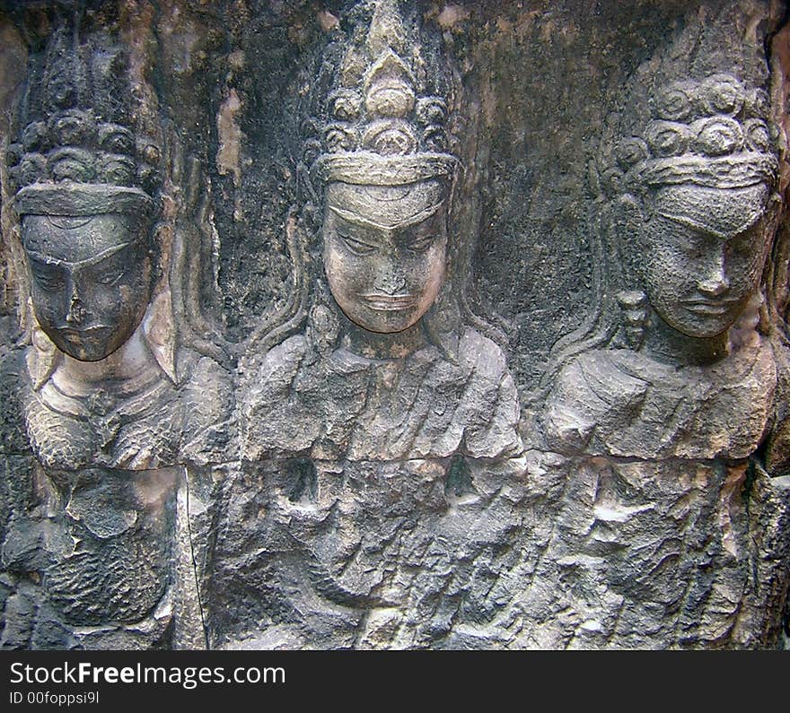 Carving of three dancers in Cambodia's Angkor Wat