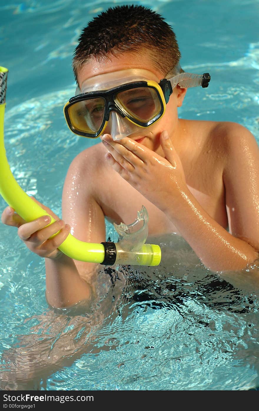 Kid with snorkeling equipment in the water. Kid with snorkeling equipment in the water