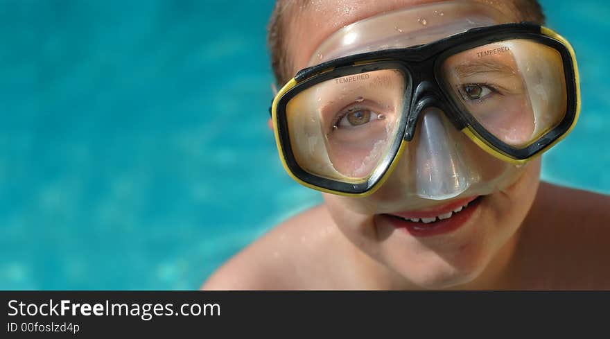 Boy in diving mask on a hot summer day; horizontal banner with plenty of space for copy. Boy in diving mask on a hot summer day; horizontal banner with plenty of space for copy