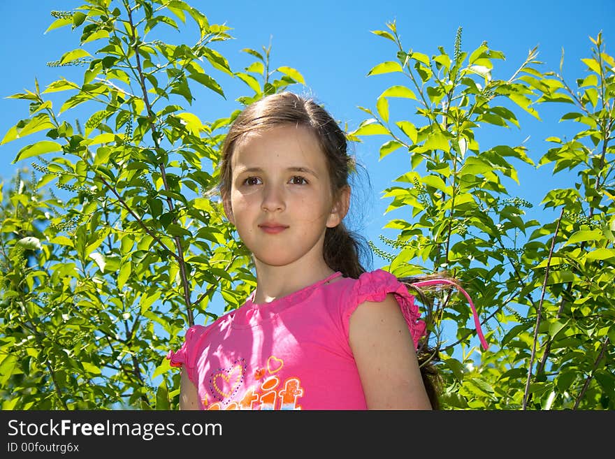 Beautiful young girl looking dreamy on the background of nature. Beautiful young girl looking dreamy on the background of nature