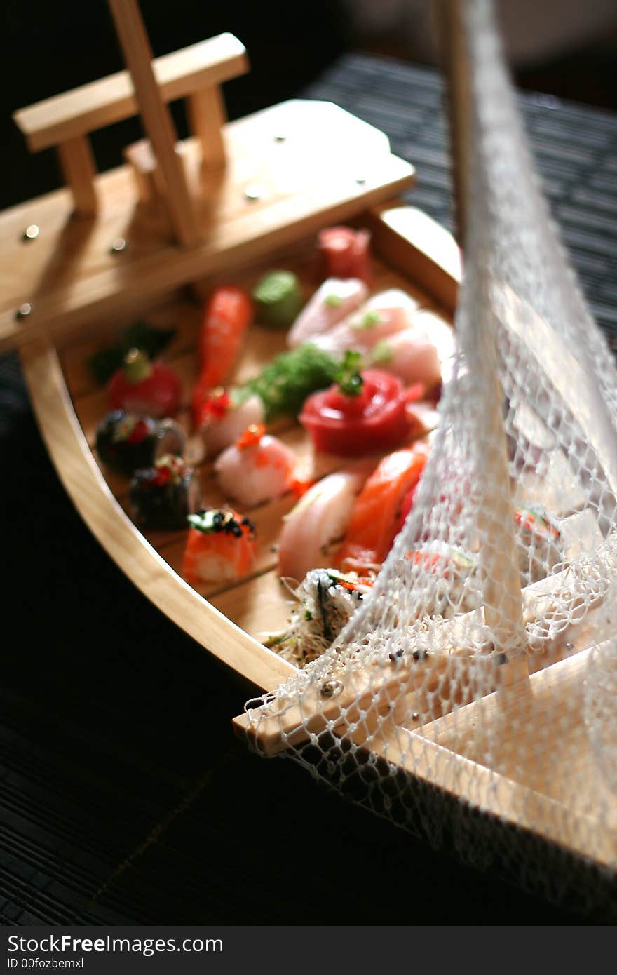 An assortment of sushi on a typical sushi boat used at Japanese restaurants