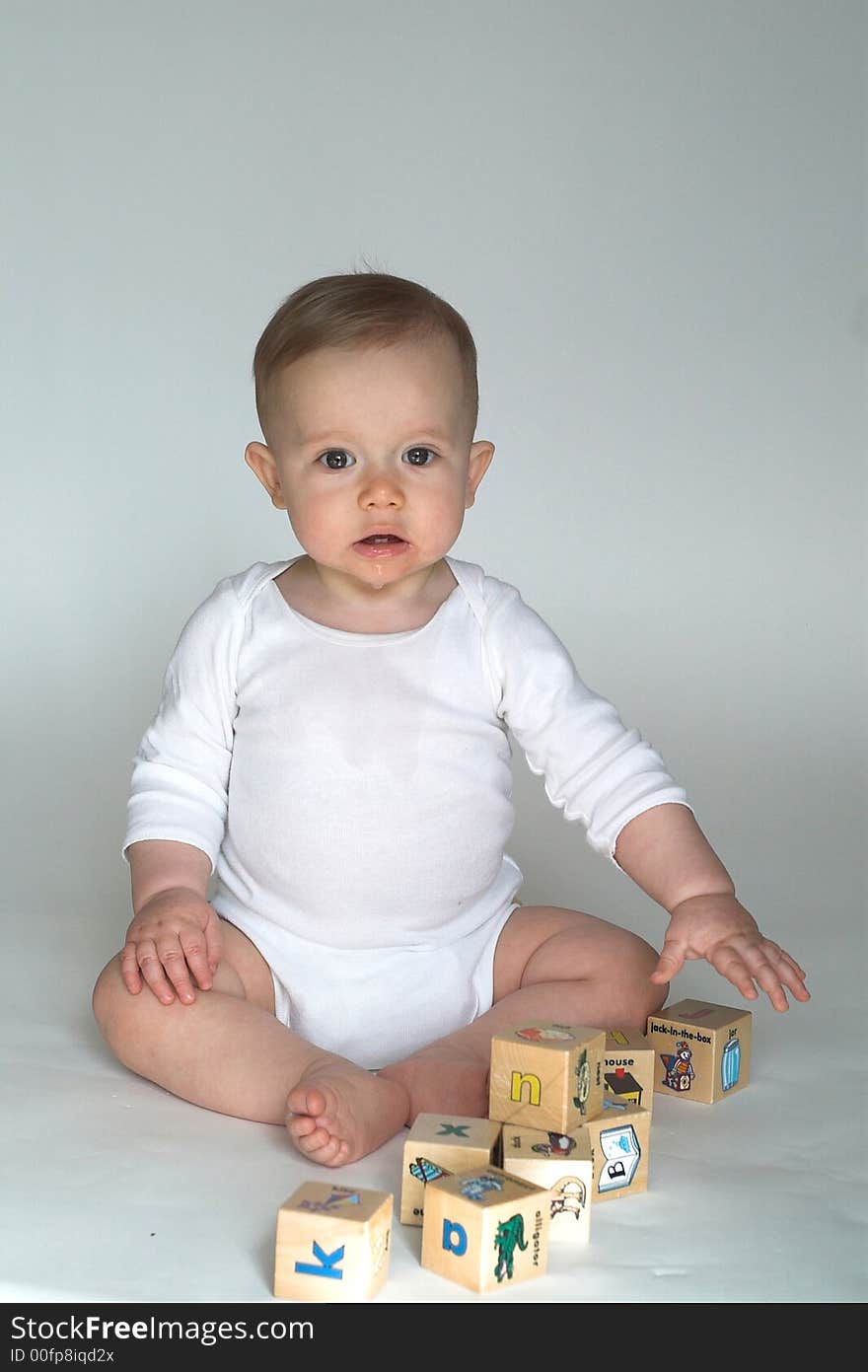 Image of cute baby playing with alphabet blocks. Image of cute baby playing with alphabet blocks