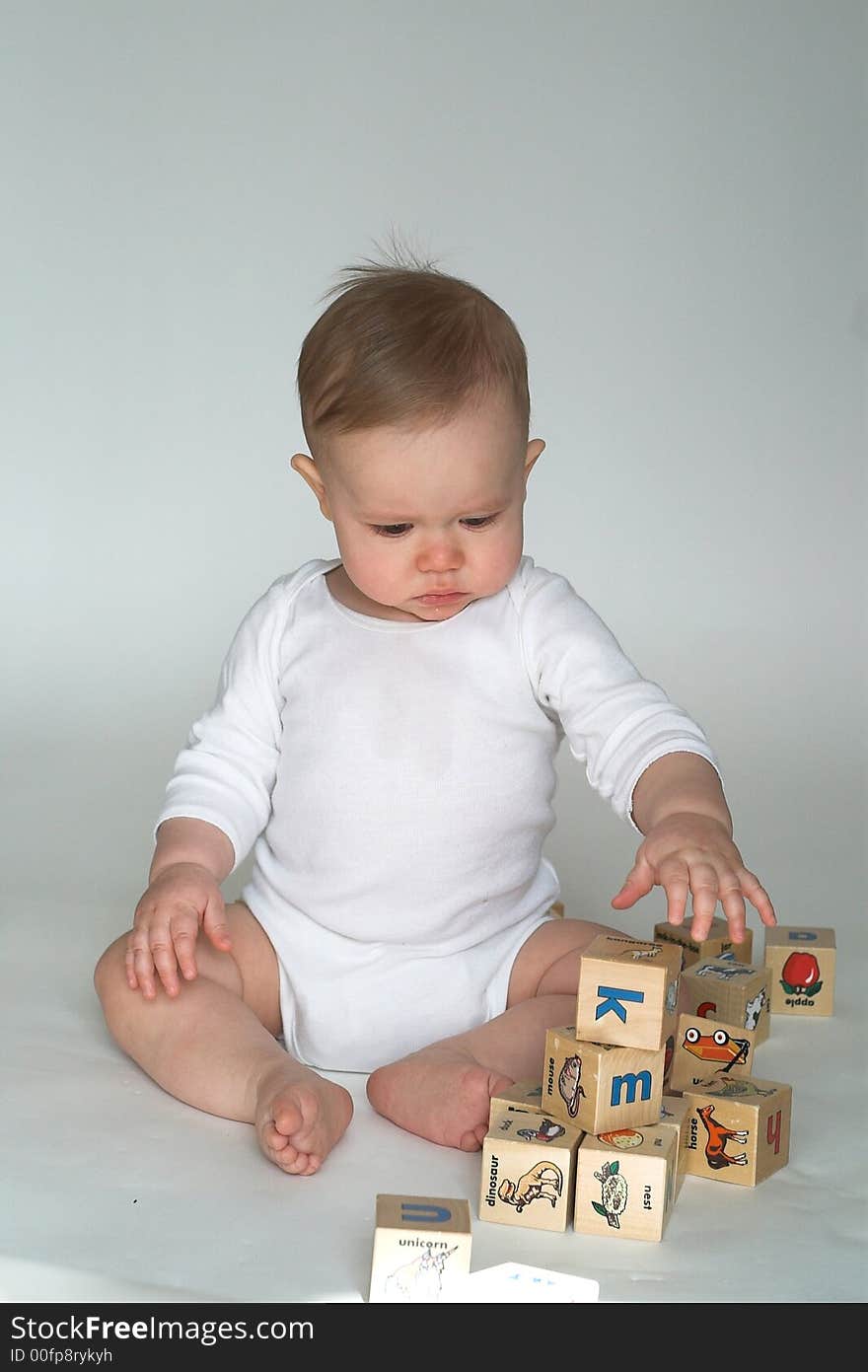 Image of cute baby playing with alphabet blocks. Image of cute baby playing with alphabet blocks