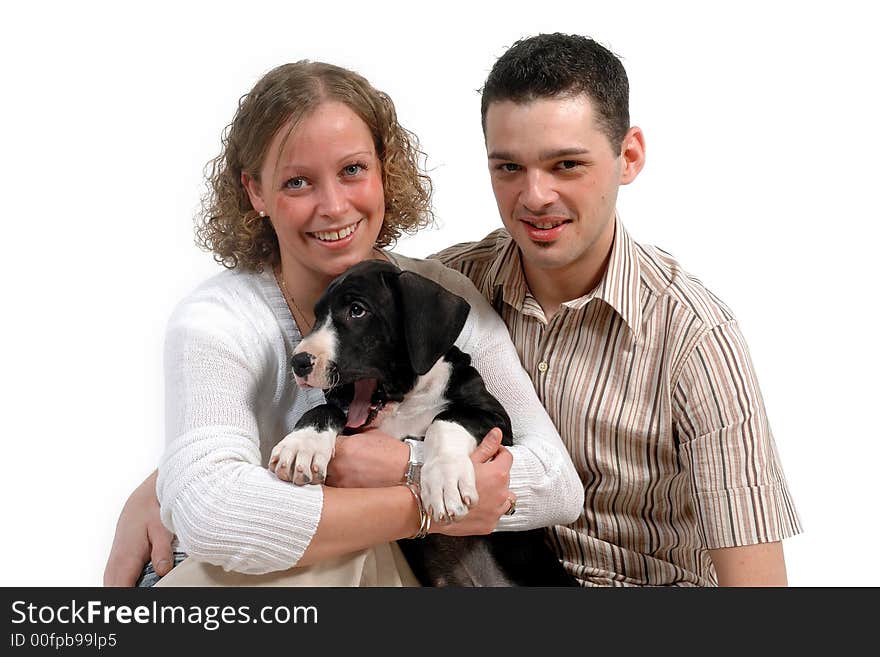 Portrait of a young happy couple and their sweet puppy. Portrait of a young happy couple and their sweet puppy.