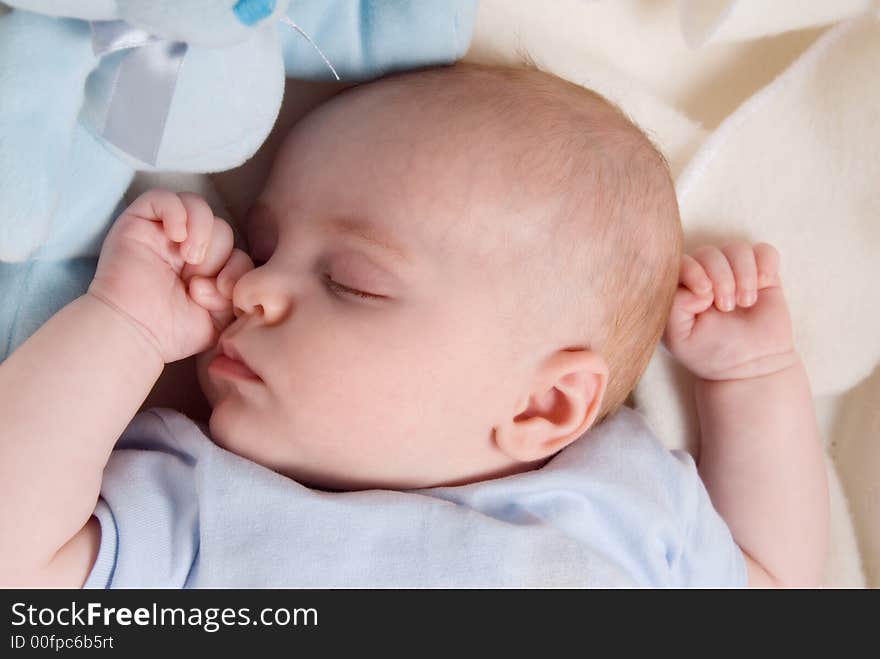 Cute baby boy dreaming in his bed. Cute baby boy dreaming in his bed