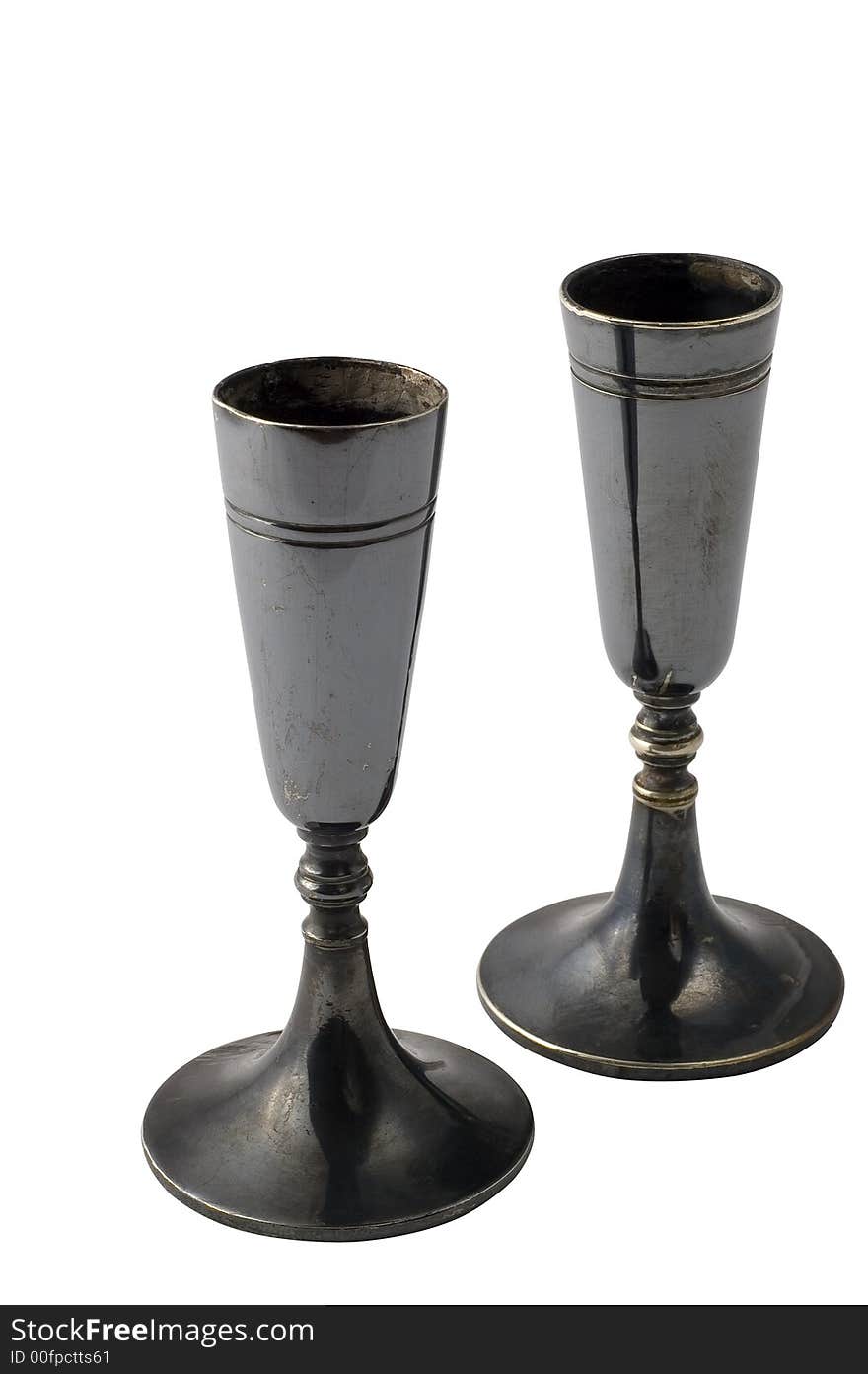 Two ancient candlesticks on white background