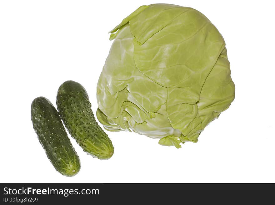 Close-up of cabbage and green cucumbers on white