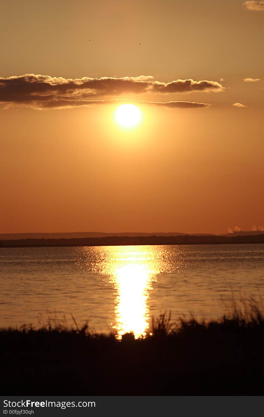 A beautiful color sun set on a beach. A beautiful color sun set on a beach