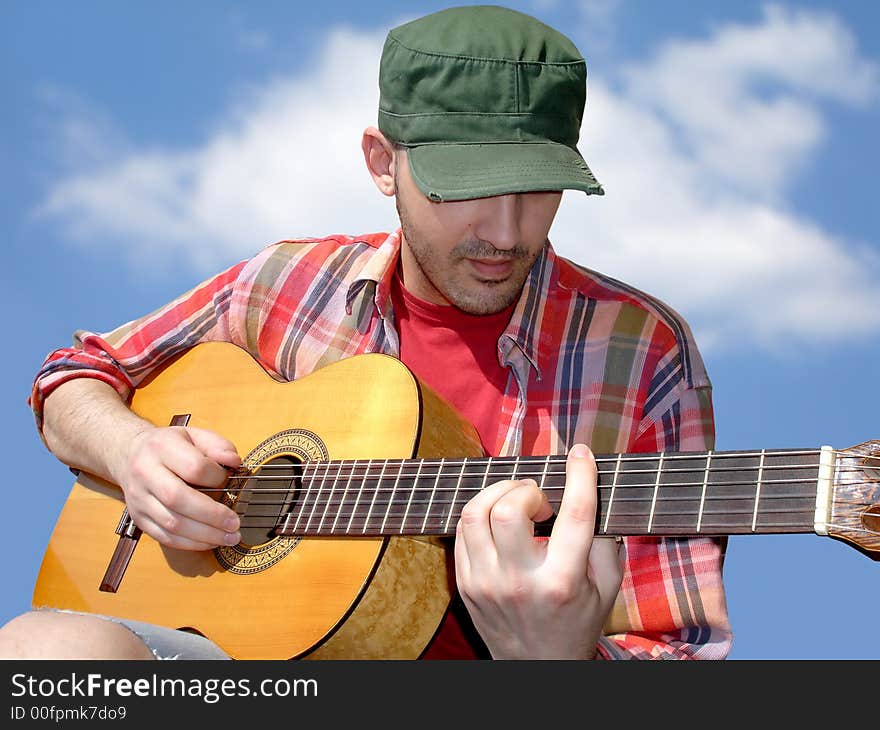 Young man playing acoustic guitar . Young man playing acoustic guitar