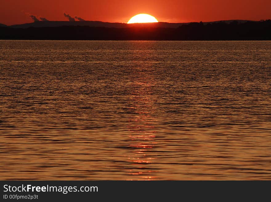 A beautiful color sun set on a beach. A beautiful color sun set on a beach