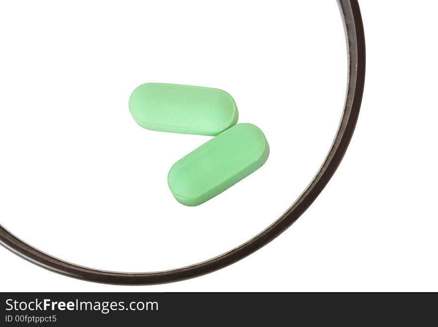 Close up of two green pills