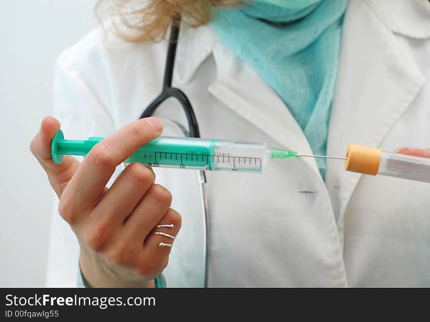 Female doctor preparing injection shot