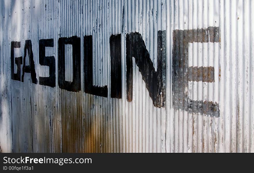 This is a picture of an old sign hand painted on a corrugated steel wall from an old abandoned gas station. This is a picture of an old sign hand painted on a corrugated steel wall from an old abandoned gas station.