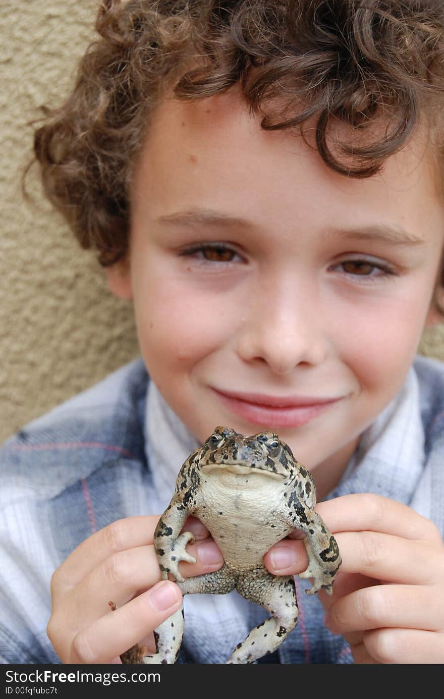 Boy happy to have found and holding a huge California native toad. Boy happy to have found and holding a huge California native toad