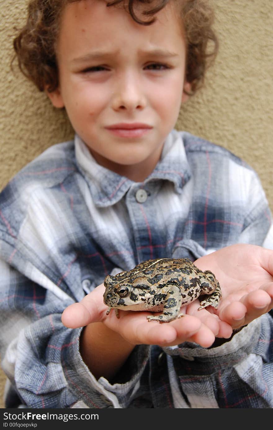 Boy happy to have found and holding a huge California native toad. Boy happy to have found and holding a huge California native toad