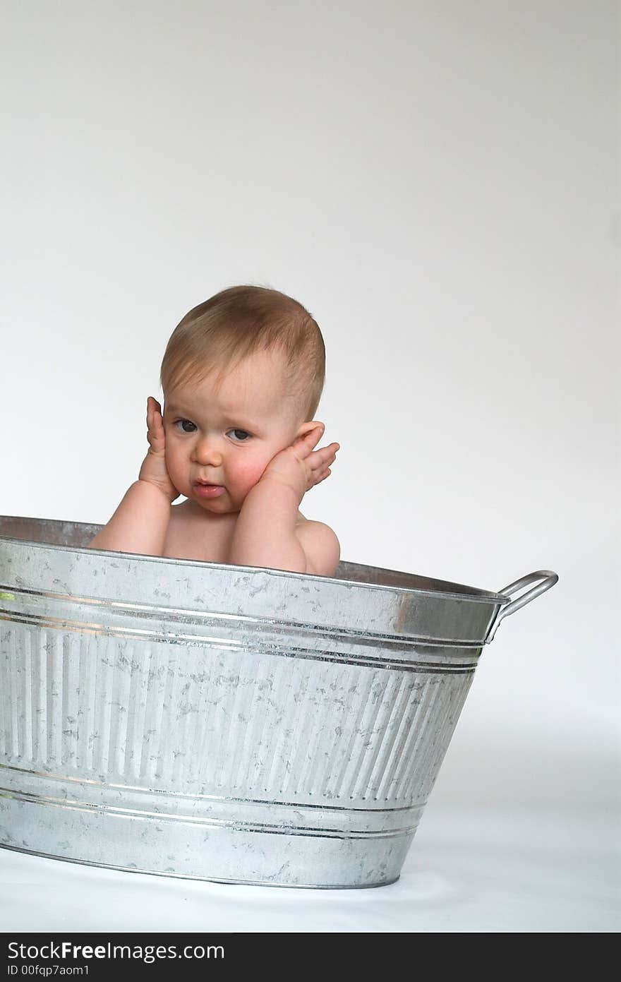 Image of cute baby sitting in a galvanized tub. Image of cute baby sitting in a galvanized tub