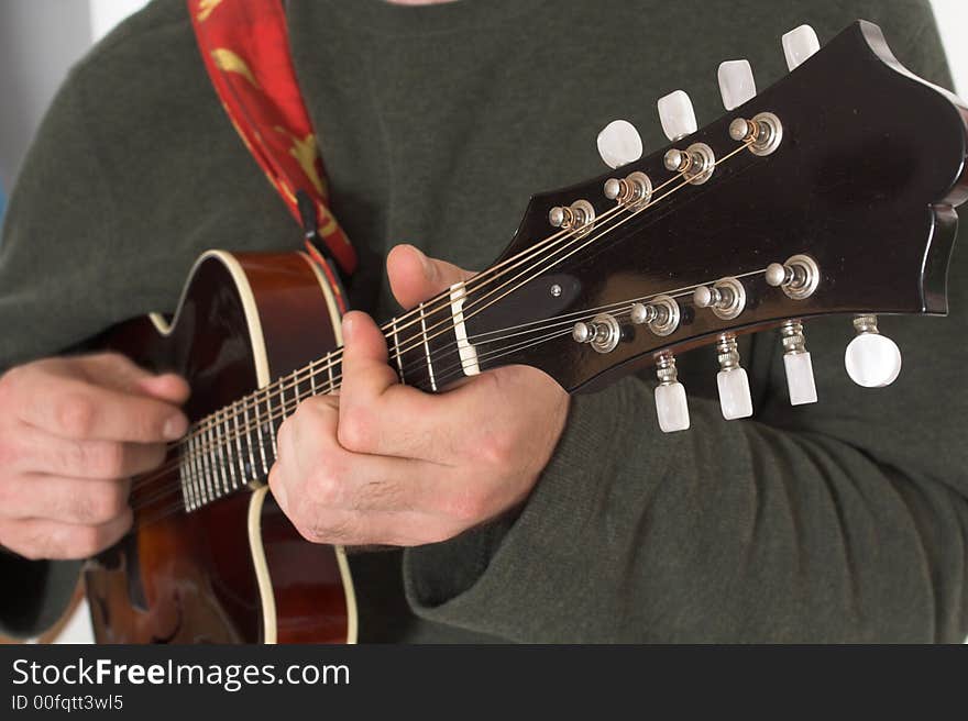 Close up of man playing guitare over white background