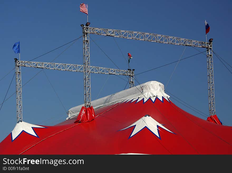 The top of a coloured circus tent on a blue sky. The top of a coloured circus tent on a blue sky