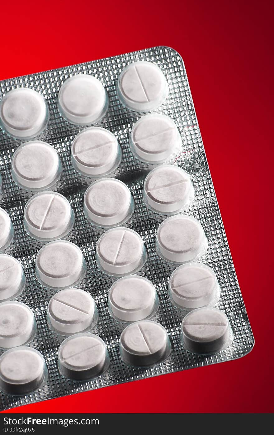 White tablets in packing on an red background. White tablets in packing on an red background