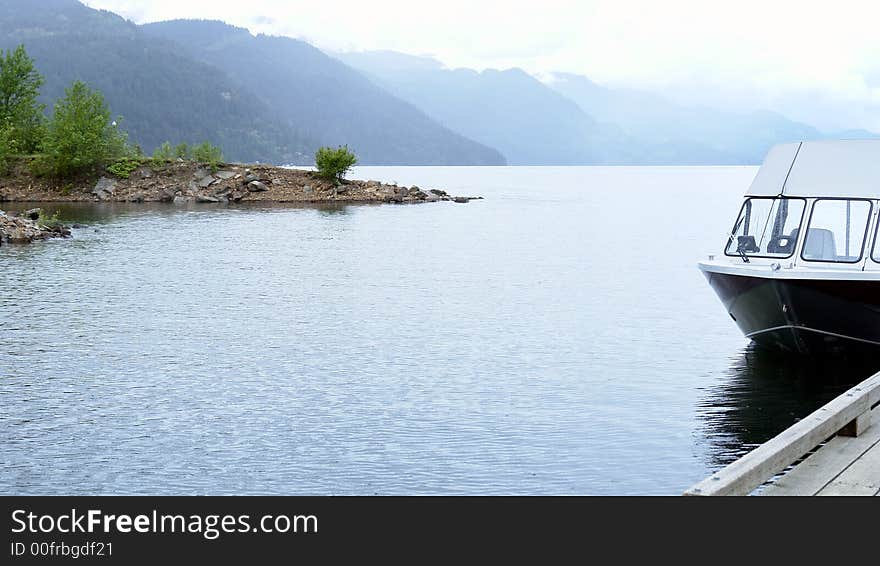 Gloomy morning at Harrison Lake with a fishing charter boat at the dock