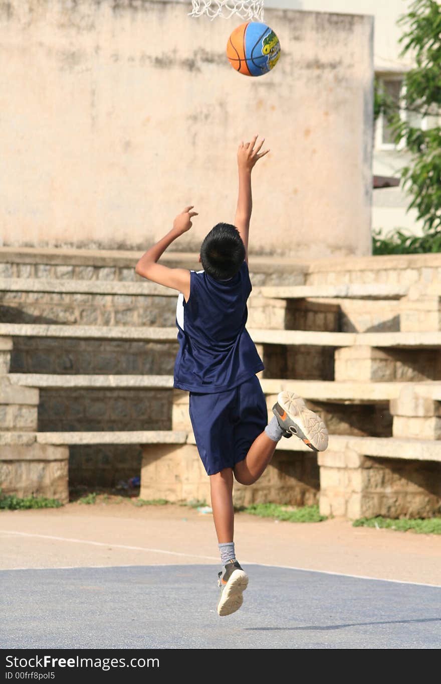 A young boy (10-12) trying to score a basket. A young boy (10-12) trying to score a basket