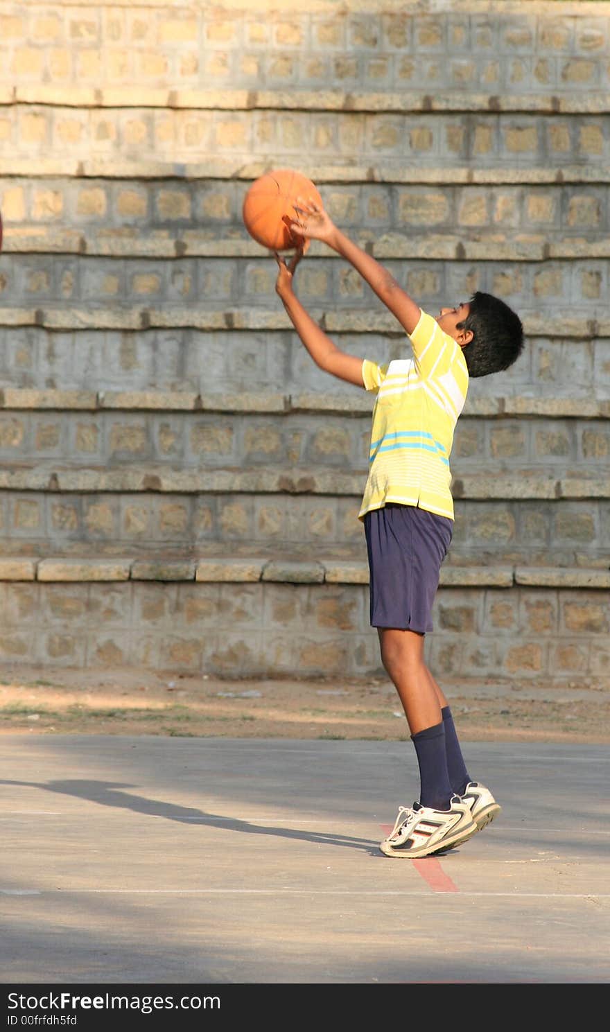 A young boy (10-12) trying to score a basket. A young boy (10-12) trying to score a basket