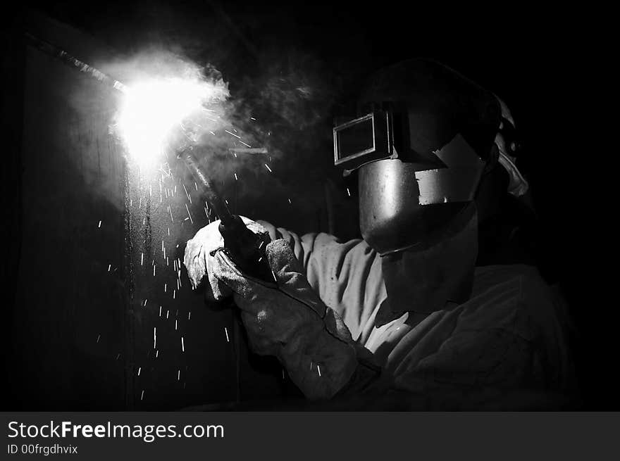 Welder under ship at night working. Welder under ship at night working