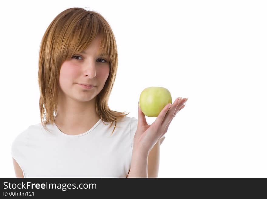 The girl holds a green apple on a palm