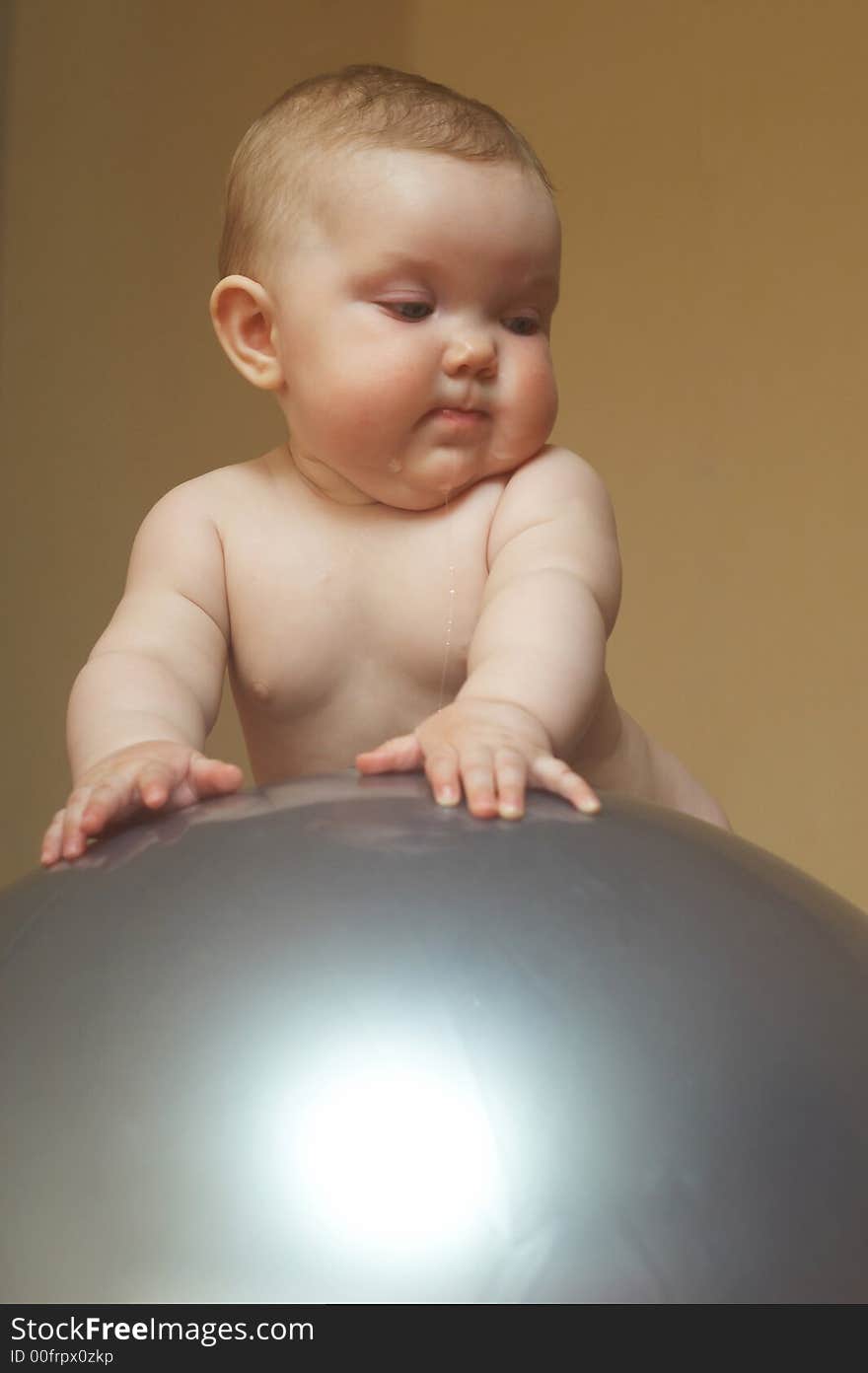 An image of a baby on the big ball. An image of a baby on the big ball