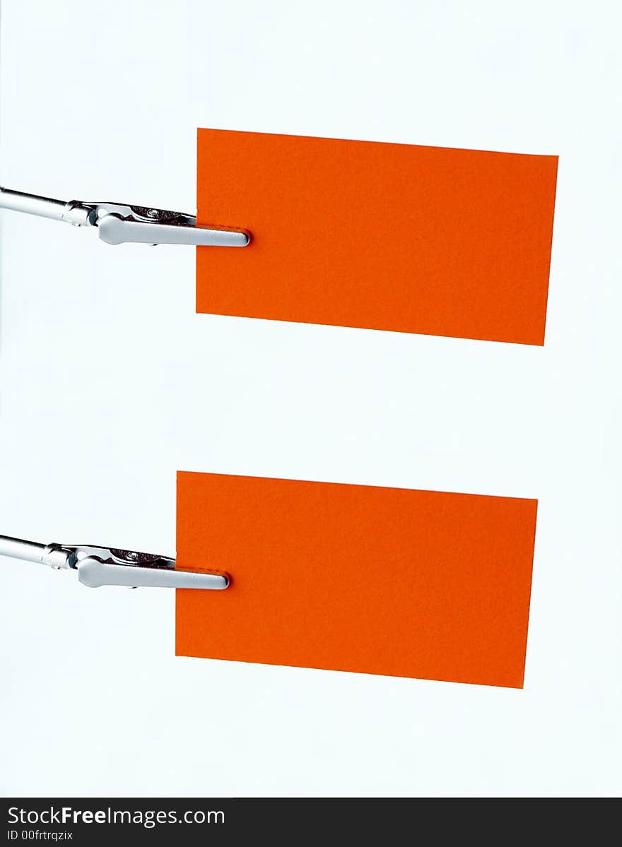 Two  orange notice-cards on metal-clip. Two  orange notice-cards on metal-clip