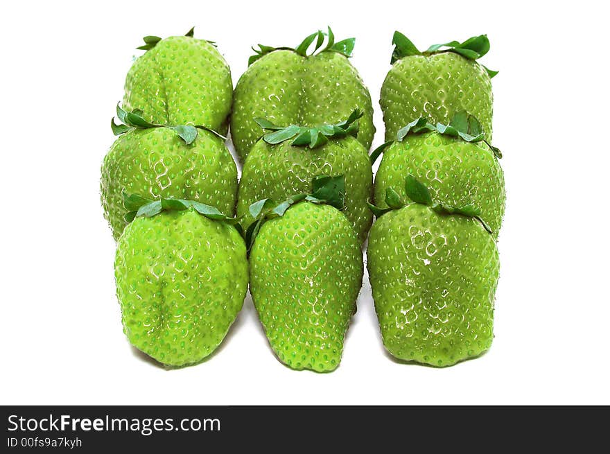 Green unripe Strawberries on a white background