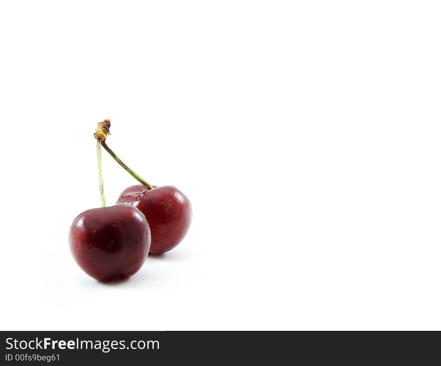 Two cherries isolated on a white background