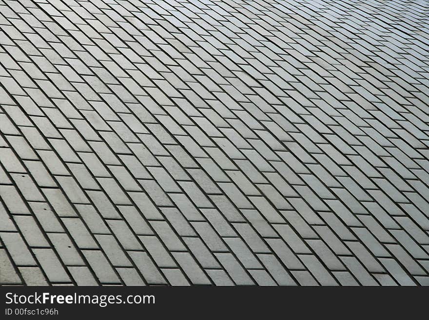 Background from a tile with geometrical figure laid on sidewalk.