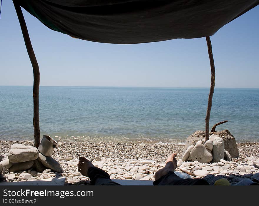 Sombody lie on a beach in shadow. Sombody lie on a beach in shadow