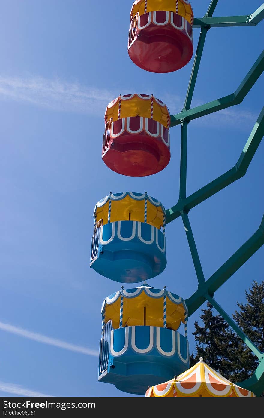 4 multi-colored ferris wheel gondolas against a clear blue sky See more playfull pictures. 4 multi-colored ferris wheel gondolas against a clear blue sky See more playfull pictures