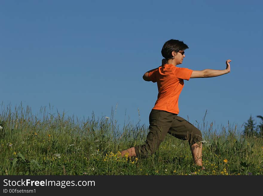 Woman making of the stretching in full nature. Woman making of the stretching in full nature