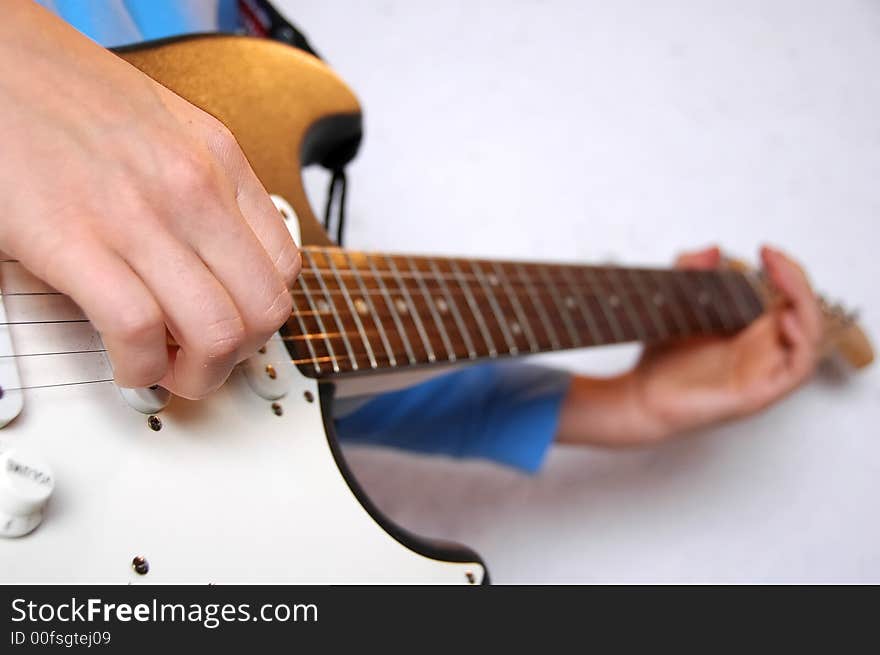 Guitar playing detail on white background