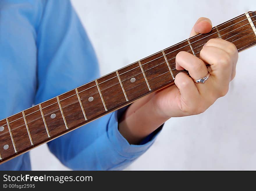 Detail of woman playing the guitar. Detail of woman playing the guitar