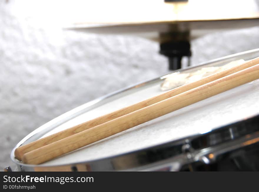 Snare drum and Sticks with hihat in background