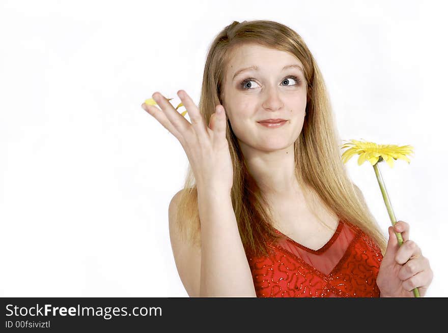 Attractive blond plukcing petals from a daisy. Attractive blond plukcing petals from a daisy